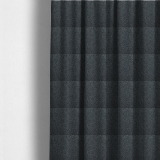 The fabric used to create these made-to-measure curtains is a deep, obsidian Black. Unlike a flat solid, this fabric uses a dense basket weave to create a rich, textured surface. The interlacing yarns catch the light in a way that provides a soft charcoal sheen, adding depth to the dark palette.