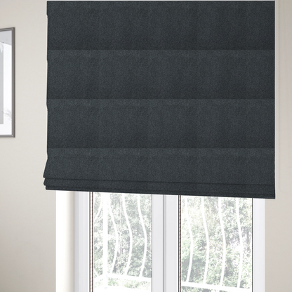 The fabric used to create these Roman blinds is a deep, obsidian Black. Unlike a flat solid, this fabric uses a dense basket weave to create a rich, textured surface. The interlacing yarns catch the light in a way that provides a soft charcoal sheen, adding depth to the dark palette.