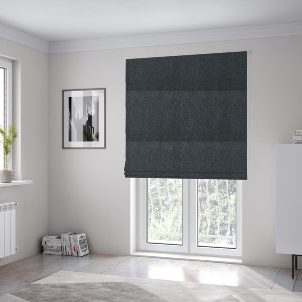 The fabric used to create these Roman blinds is a deep, obsidian Black. Unlike a flat solid, this fabric uses a dense basket weave to create a rich, textured surface. The interlacing yarns catch the light in a way that provides a soft charcoal sheen, adding depth to the dark palette.