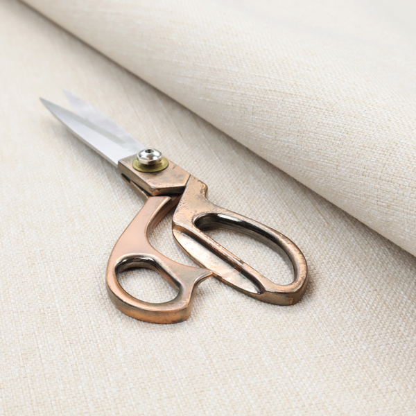 A light beige woven fabric with a subtle, textured grid pattern.