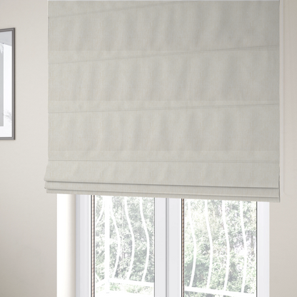 The fabric used to create these Roman blinds is a light beige woven fabric with a subtle, textured grid pattern.