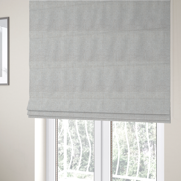 The fabric used to create these Roman blinds is a marl grey woven fabric with a heathered, multi-tonal textured finish.