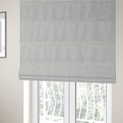 The fabric used to create these Roman blinds is a marl grey woven fabric with a heathered, multi-tonal textured finish.