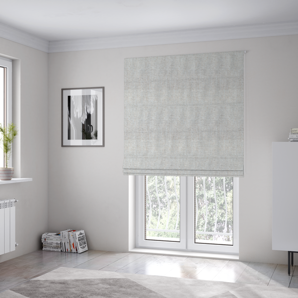 The fabric used to create these Roman blinds is a marl grey woven fabric with a heathered, multi-tonal textured finish.