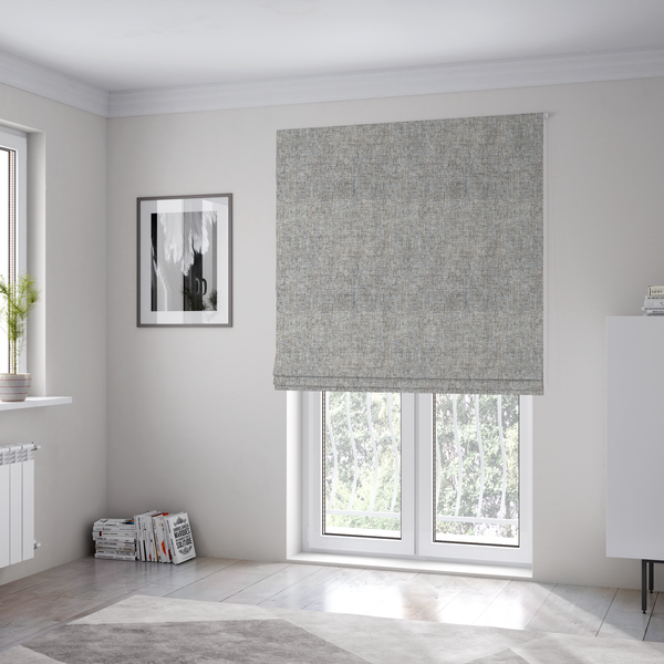 The fabric used to create these Roman blinds is a ash brown woven fabric with a multi-tonal, heathered texture.