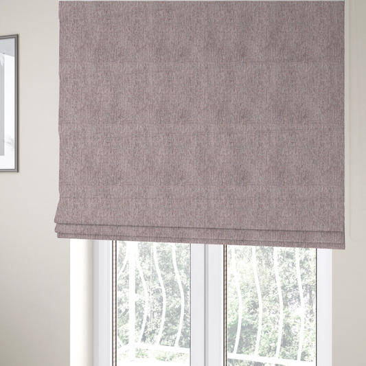 The fabric used to create these Roman blinds is a dusty rose woven fabric with a multi-tonal, heathered texture.