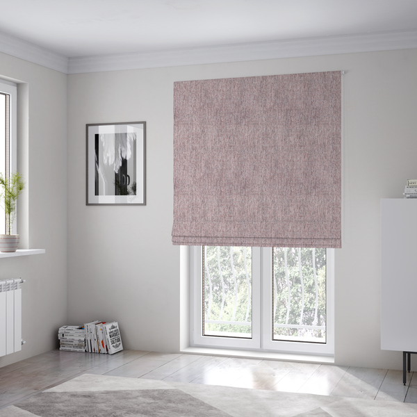 The fabric used to create these Roman blinds is a dusty rose woven fabric with a multi-tonal, heathered texture.