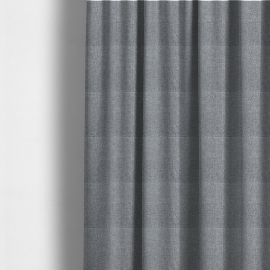 The fabric used to create these made-to-measure curtains is a steel grey woven fabric with a dense, multi-tonal heathered texture.