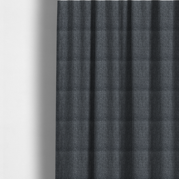 The fabric used to create these made-to-measure curtains is a dark charcoal grey woven fabric with a heavy, multi-tonal heathered texture.