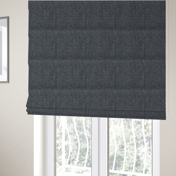 The fabric used to create these Roman blinds is a dark charcoal grey woven fabric with a heavy, multi-tonal heathered texture.