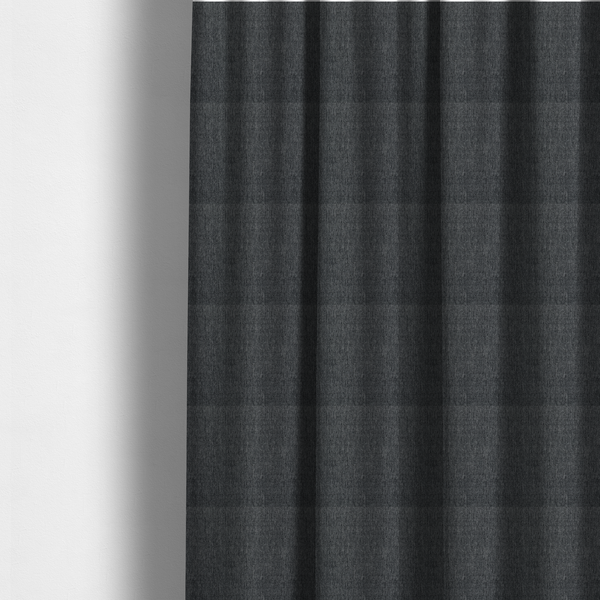 The fabric used to create these made-to-measure curtains is a black and grey woven fabric with a tight, salt-and-pepper heathered texture.