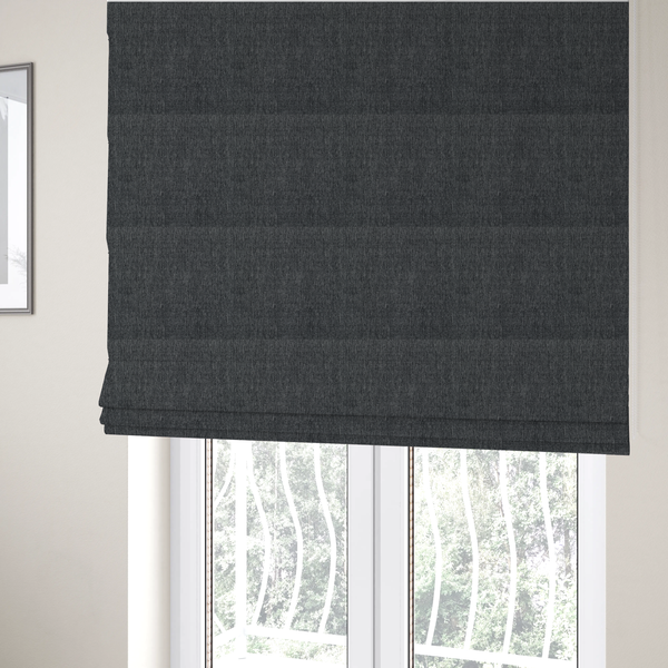The fabric used to create these Roman blinds is a black and grey woven fabric with a tight, salt-and-pepper heathered texture.
