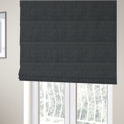 The fabric used to create these Roman blinds is a black and grey woven fabric with a tight, salt-and-pepper heathered texture.