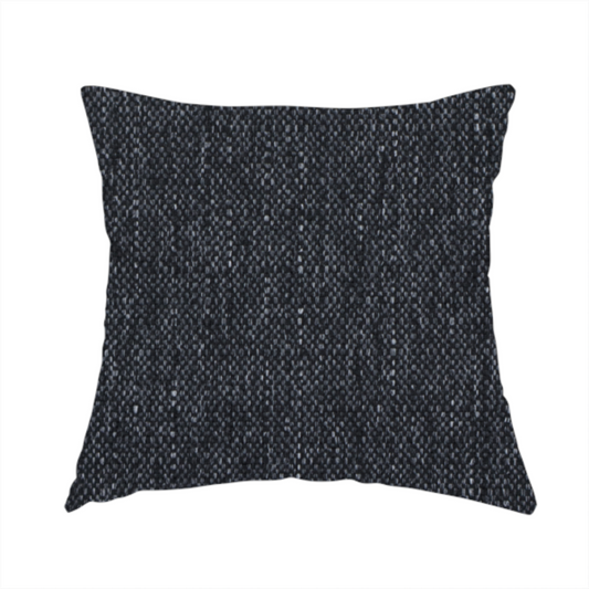 The fabric used to create this handmade cushion is a deep onyx black woven fabric with a fine, heathered texture.