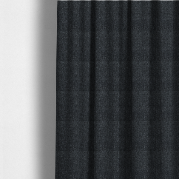 The fabric used to create these made-to-measure curtains is a deep onyx black woven fabric with a fine, heathered texture.
