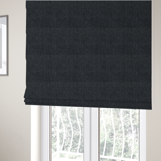 The fabric used to create these Roman blinds is a deep onyx black woven fabric with a fine, heathered texture.