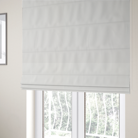 The fabric used to create these Roman blinds is a solid white, water-repellent velvet fabric. The surface features a dense, low-profile pile that creates a soft, matte appearance with a subtle, plush texture. The uniform white colour and specialized finish give it a clean, luxurious, and high-performance look.