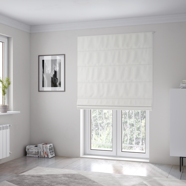 The fabric used to create these Roman blinds is a solid white, water-repellent velvet fabric. The surface features a dense, low-profile pile that creates a soft, matte appearance with a subtle, plush texture. The uniform white colour and specialized finish give it a clean, luxurious, and high-performance look.