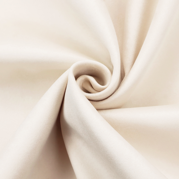 Annecy Water Repellent Velvet in Cream. The fabric features a dense, soft pile with a subtle matte sheen. The warm, off-white cream tone is uniform throughout, offering a luxurious and durable finish suitable for high-end upholstery.