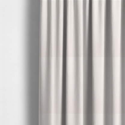 The fabric used to create these curtains features a dense, soft pile with a subtle matte sheen. The warm, off-white cream tone is uniform throughout, offering a luxurious and durable finish suitable for high-end upholstery.