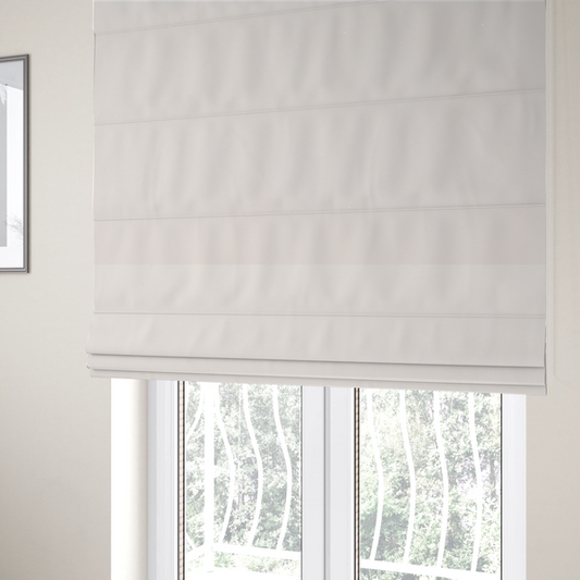 The fabric used to create these Roman blinds features a dense, soft pile with a subtle matte sheen. The warm, off-white cream tone is uniform throughout, offering a luxurious and durable finish suitable for high-end upholstery.