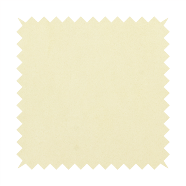 Annecy Water Repellent Velvet in Ivory. The fabric displays a dense, plush pile with a soft matte finish in a warm, buttery off-white shade. Its uniform texture and specialized water-resistant coating make it a luxurious yet practical choice for upholstery.