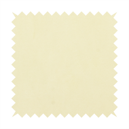 Annecy Water Repellent Velvet in Ivory. The fabric displays a dense, plush pile with a soft matte finish in a warm, buttery off-white shade. Its uniform texture and specialized water-resistant coating make it a luxurious yet practical choice for upholstery.