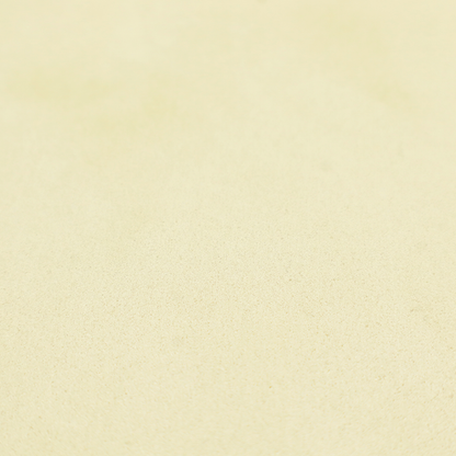 Annecy Water Repellent Velvet in Ivory. The fabric displays a dense, plush pile with a soft matte finish in a warm, buttery off-white shade. Its uniform texture and specialized water-resistant coating make it a luxurious yet practical choice for upholstery.