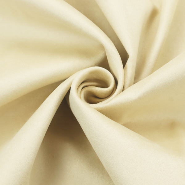 Annecy Water Repellent Velvet in Ivory. The fabric displays a dense, plush pile with a soft matte finish in a warm, buttery off-white shade. Its uniform texture and specialized water-resistant coating make it a luxurious yet practical choice for upholstery.