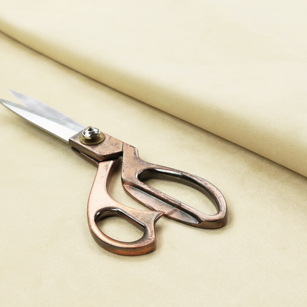 Annecy Water Repellent Velvet in Ivory. The fabric displays a dense, plush pile with a soft matte finish in a warm, buttery off-white shade. Its uniform texture and specialized water-resistant coating make it a luxurious yet practical choice for upholstery.