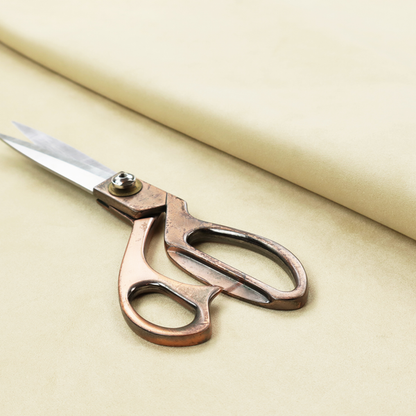 Annecy Water Repellent Velvet in Ivory. The fabric displays a dense, plush pile with a soft matte finish in a warm, buttery off-white shade. Its uniform texture and specialized water-resistant coating make it a luxurious yet practical choice for upholstery.