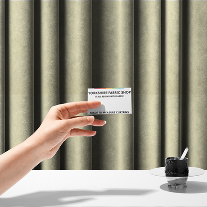 The fabric used to create these made-to-measure curtains displays a dense, plush pile with a soft matte finish in a warm, buttery off-white shade. Its uniform texture and specialized water-resistant coating make it a luxurious yet practical choice for upholstery.