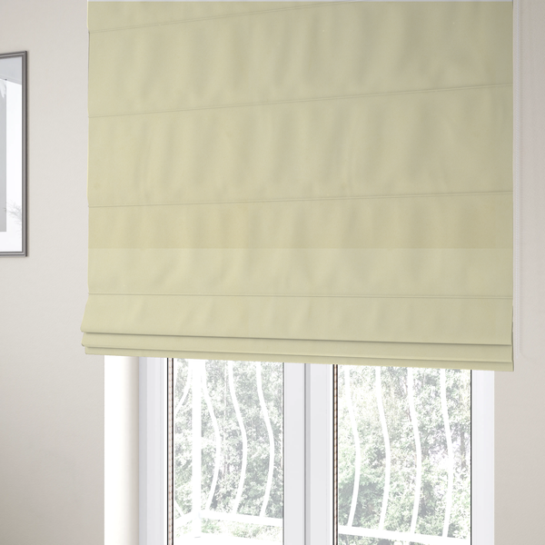 The fabric used to create these Roman blinds displays a dense, plush pile with a soft matte finish in a warm, buttery off-white shade. Its uniform texture and specialized water-resistant coating make it a luxurious yet practical choice for upholstery.