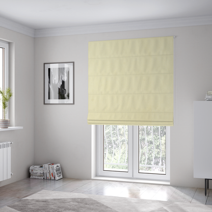 The fabric used to create these Roman blinds displays a dense, plush pile with a soft matte finish in a warm, buttery off-white shade. Its uniform texture and specialized water-resistant coating make it a luxurious yet practical choice for upholstery.