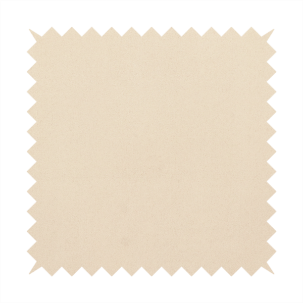 Annecy Water Repellent Velvet in Champagne. The fabric features a fine, dense pile with a soft matte finish in a pale, sandy-beige tone. This high-performance upholstery material offers a luxurious feel with built-in moisture resistance for added durability.