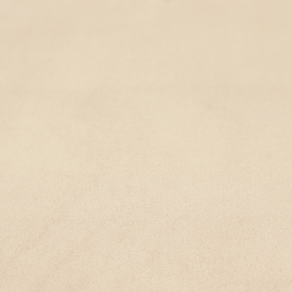 Annecy Water Repellent Velvet in Champagne. The fabric features a fine, dense pile with a soft matte finish in a pale, sandy-beige tone. This high-performance upholstery material offers a luxurious feel with built-in moisture resistance for added durability.