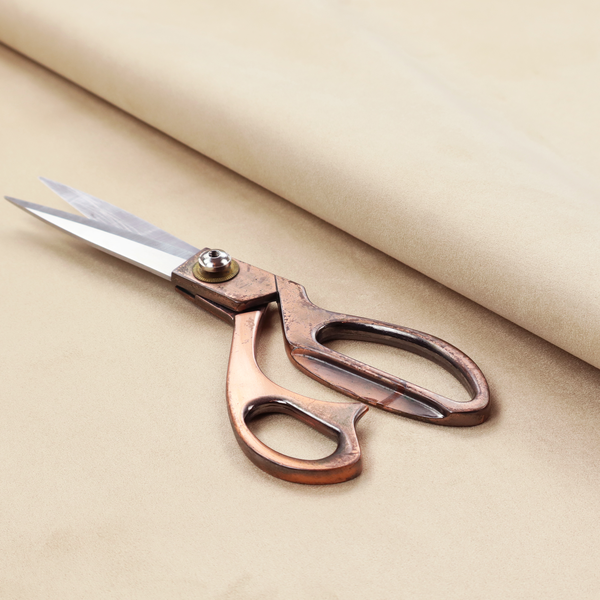 Annecy Water Repellent Velvet in Champagne. The fabric features a fine, dense pile with a soft matte finish in a pale, sandy-beige tone. This high-performance upholstery material offers a luxurious feel with built-in moisture resistance for added durability.