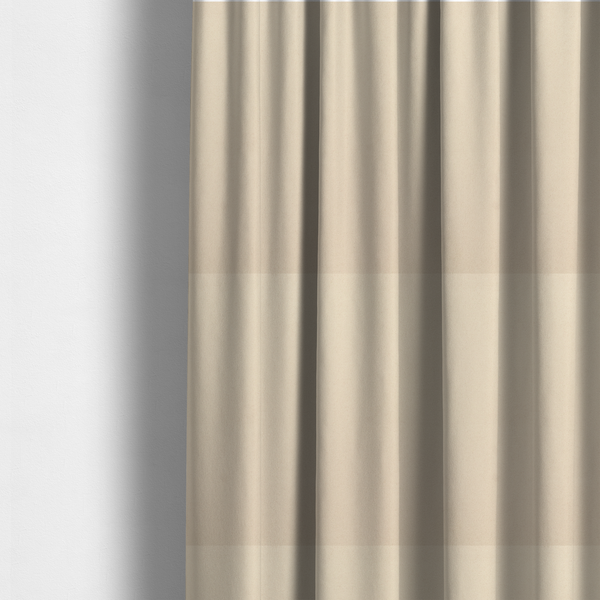 The fabric used to create these made-to-measure curtains features a fine, dense pile with a soft matte finish in a pale, sandy-beige tone. This high-performance upholstery material offers a luxurious feel with built-in moisture resistance for added durability.