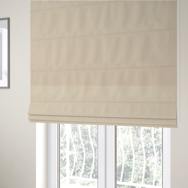 the fabric used to create these Roman blinds features a fine, dense pile with a soft matte finish in a pale, sandy-beige tone. This high-performance upholstery material offers a luxurious feel with built-in moisture resistance for added durability.