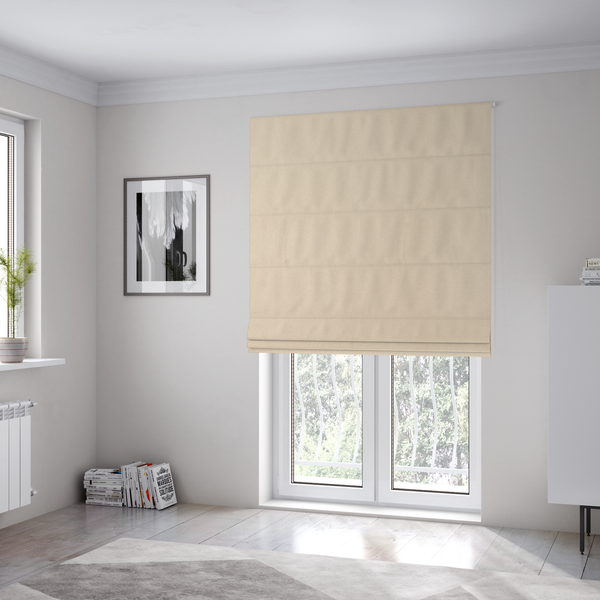 the fabric used to create these Roman blinds features a fine, dense pile with a soft matte finish in a pale, sandy-beige tone. This high-performance upholstery material offers a luxurious feel with built-in moisture resistance for added durability.