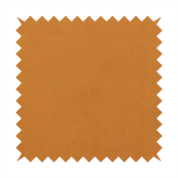 Annecy Water Repellent Velvet in Ochre. The fabric features a rich, dense pile with a soft matte finish in a warm, earthy mustard-orange tone. This high-performance upholstery material combines a luxurious feel with a specialized water-resistant coating for enhanced durability.