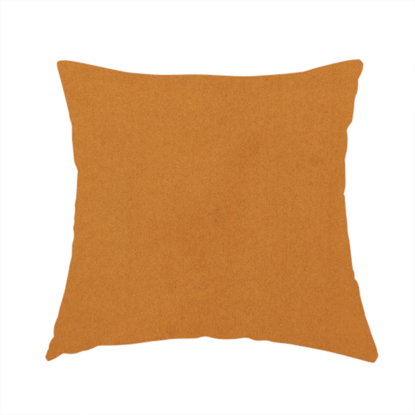 The fabric used to create this handmade cushion features a rich, dense pile with a soft matte finish in a warm, earthy mustard-orange tone. This high-performance upholstery material combines a luxurious feel with a specialized water-resistant coating for enhanced durability.