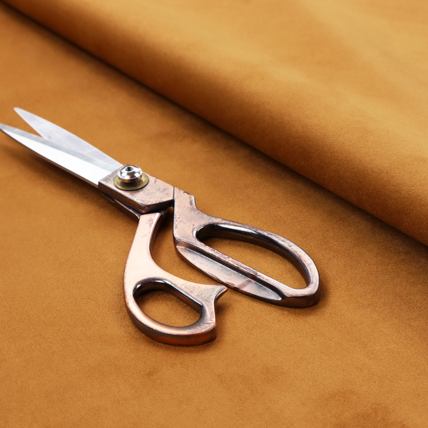 Annecy Water Repellent Velvet in Ochre. The fabric features a rich, dense pile with a soft matte finish in a warm, earthy mustard-orange tone. This high-performance upholstery material combines a luxurious feel with a specialized water-resistant coating for enhanced durability.