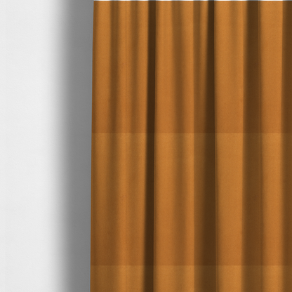 The fabric used to create these made-to-measure curtains features a rich, dense pile with a soft matte finish in a warm, earthy mustard-orange tone. This high-performance upholstery material combines a luxurious feel with a specialized water-resistant coating for enhanced durability.