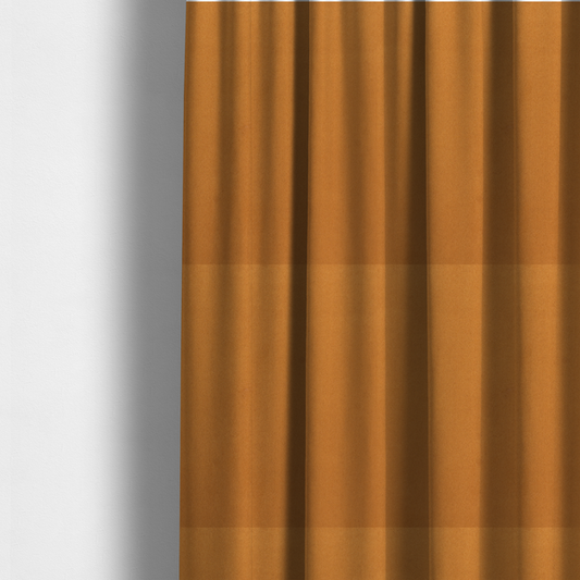 The fabric used to create these made-to-measure curtains features a rich, dense pile with a soft matte finish in a warm, earthy mustard-orange tone. This high-performance upholstery material combines a luxurious feel with a specialized water-resistant coating for enhanced durability.