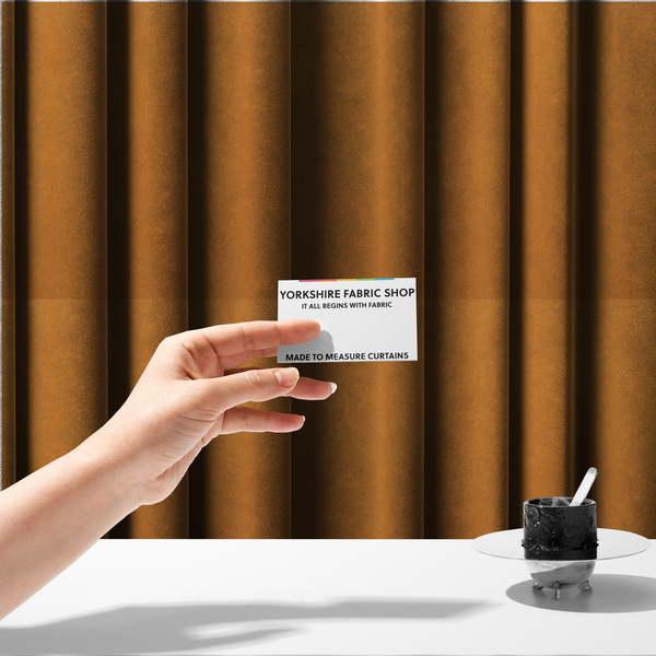 The fabric used to create these made-to-measure curtains features a rich, dense pile with a soft matte finish in a warm, earthy mustard-orange tone. This high-performance upholstery material combines a luxurious feel with a specialized water-resistant coating for enhanced durability.