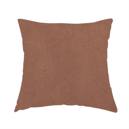 The fabric used to create this handmade cushion features a dense, plush pile with a soft matte finish in a warm, muted clay-red tone. This high-performance upholstery material offers a luxurious feel combined with a specialized water-resistant coating for lasting durability.