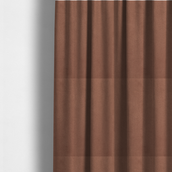 The fabric used to create these made-to-measure curtains features a dense, plush pile with a soft matte finish in a warm, muted clay-red tone. This high-performance upholstery material offers a luxurious feel combined with a specialized water-resistant coating for lasting durability.