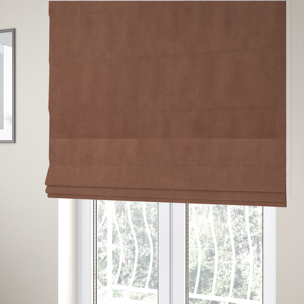 The fabric used to create these Roman blinds features a dense, plush pile with a soft matte finish in a warm, muted clay-red tone. This high-performance upholstery material offers a luxurious feel combined with a specialized water-resistant coating for lasting durability.