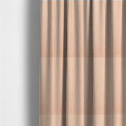 The fabric used to create these made-to-measure curtains features a dense, soft pile with a matte finish in a delicate, pale peachy-pink tone. This high-performance upholstery material offers a luxurious feel and a specialized water-resistant coating, making it both elegant and durable.